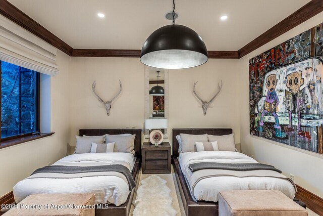 bedroom with hardwood / wood-style floors and ornamental molding