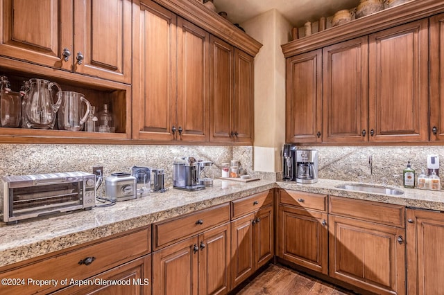 kitchen with decorative backsplash, hardwood / wood-style floors, and sink