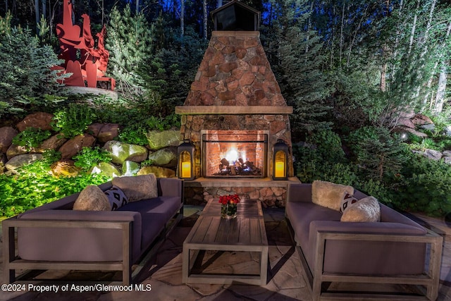 view of patio featuring an outdoor living space with a fireplace