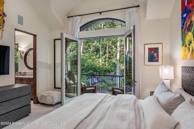 bedroom with lofted ceiling and ensuite bath