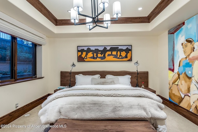 bedroom featuring a raised ceiling, ornamental molding, and a chandelier