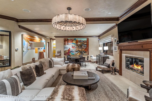 carpeted living room featuring a chandelier, ornamental molding, and a tiled fireplace