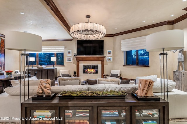 living room with a tile fireplace and a notable chandelier