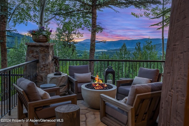 exterior space with a mountain view and an outdoor fire pit