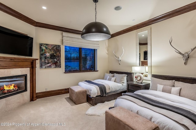 bedroom with ornamental molding, light carpet, and a tiled fireplace