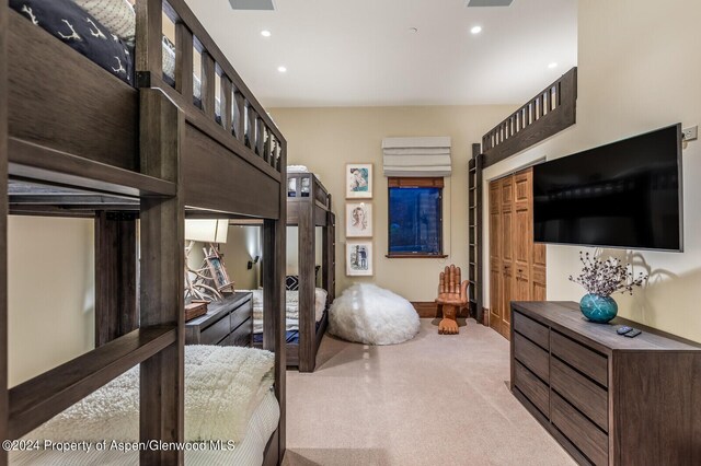 bedroom featuring a closet and light colored carpet