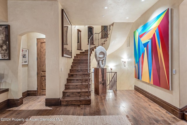 staircase with hardwood / wood-style flooring