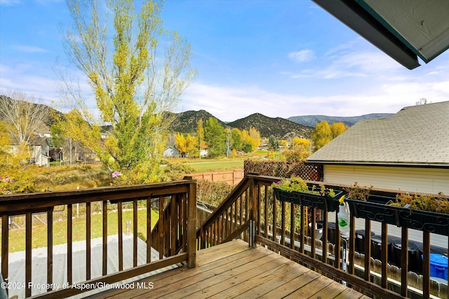 wooden deck with a mountain view