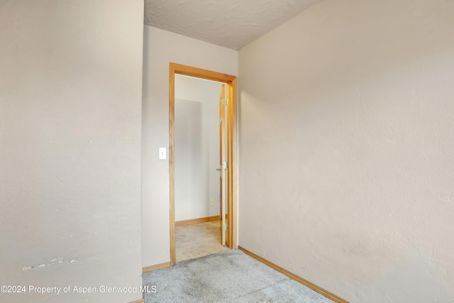 hallway featuring light carpet