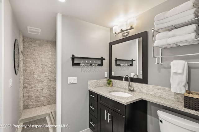 711 S Galena St Unit 17D, Aspen, CO 81611 - full bath with vanity, a stall shower, visible vents, and toilet