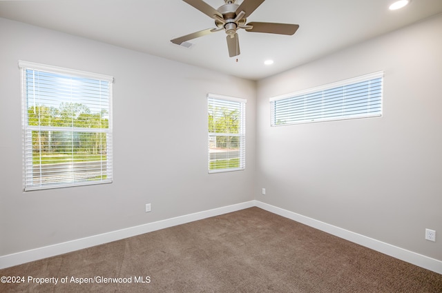 unfurnished room featuring ceiling fan, a healthy amount of sunlight, and carpet floors