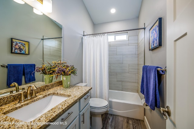 full bathroom with hardwood / wood-style flooring, vanity, toilet, and shower / bathtub combination with curtain