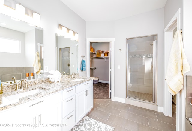 bathroom featuring tile patterned flooring, vanity, and an enclosed shower