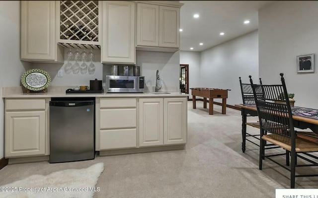 289 Sweetgrass Dr, Carbondale, CO 81623 - kitchen with refrigerator, light colored carpet, light countertops, stainless steel microwave, and a sink