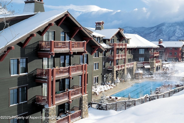 exterior space with a mountain view and a balcony