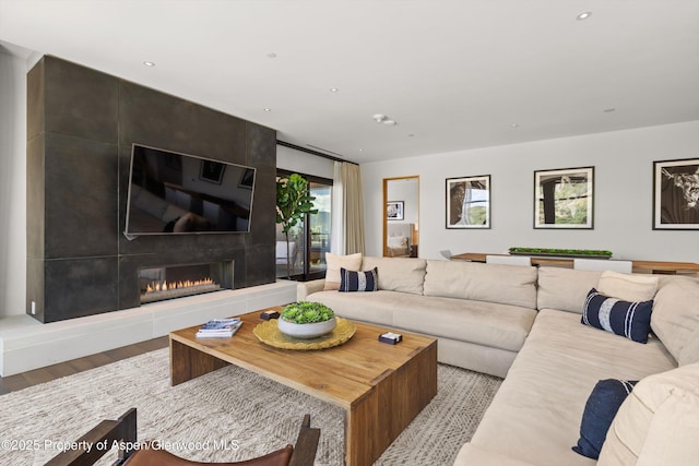 45 Wood Rd Unit 403, Snowmass Village, CO 81615 - living area with wood finished floors, a tiled fireplace, and recessed lighting