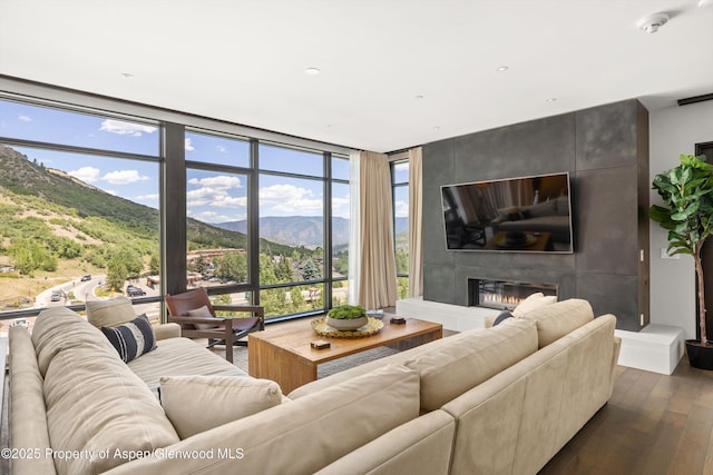 45 Wood Rd Unit 403, Snowmass Village, CO 81615 - living area featuring dark wood-style flooring and a large fireplace
