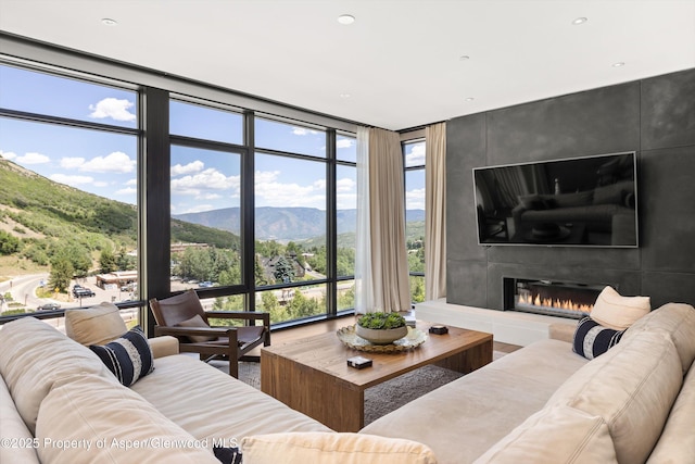 45 Wood Rd Unit 403, Snowmass Village, CO 81615 - living room with a wall of windows, a fireplace, recessed lighting, and wood finished floors