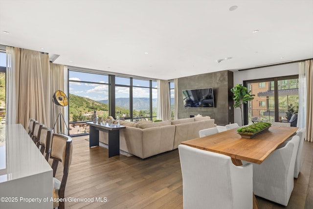 45 Wood Rd Unit 403, Snowmass Village, CO 81615 - living room featuring wood finished floors, healthy amount of natural light, a wall of windows, and recessed lighting