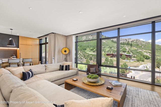 45 Wood Rd Unit 403, Snowmass Village, CO 81615 - living room featuring a wall of windows, wood finished floors, healthy amount of natural light, a mountain view, and recessed lighting