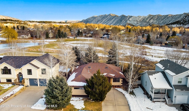 snowy aerial view featuring a mountain view