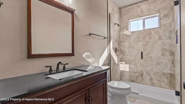 bathroom featuring vanity, toilet, and an enclosed shower