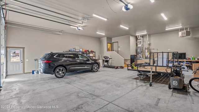 garage with a garage door opener and water heater