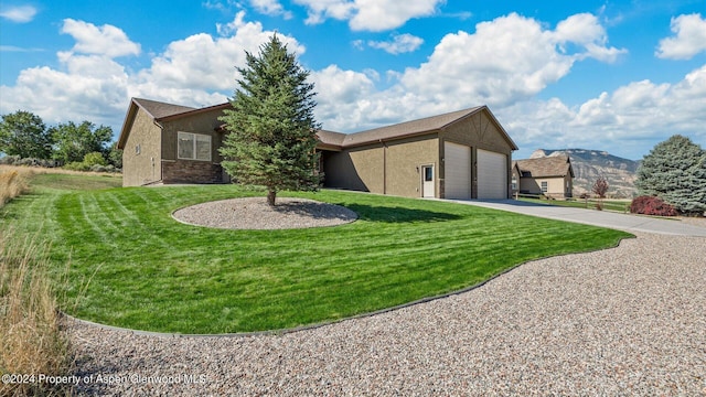 view of front of property with a garage and a front lawn