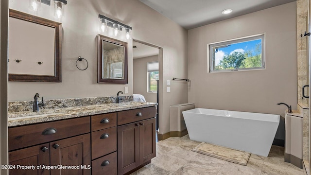 bathroom with a tub and vanity