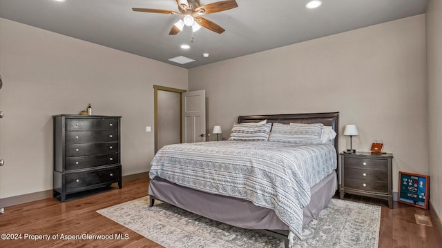 bedroom with ceiling fan and dark hardwood / wood-style floors