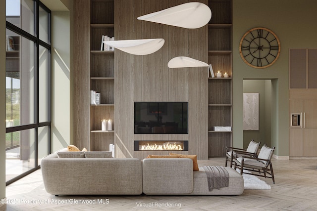 living room featuring built in shelves and light parquet floors