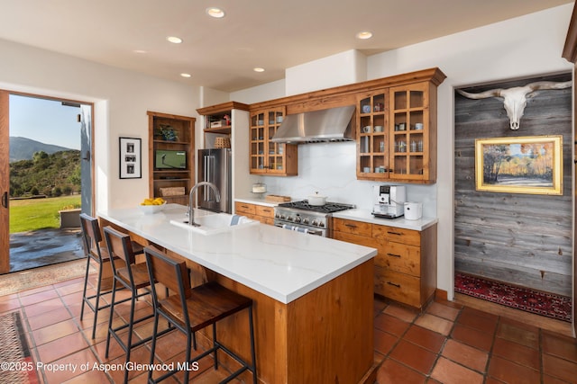 1432 Hooks Spur Rd, Basalt, CO 81621 - kitchen featuring extractor fan, high quality appliances, recessed lighting, brown cabinets, and a kitchen breakfast bar
