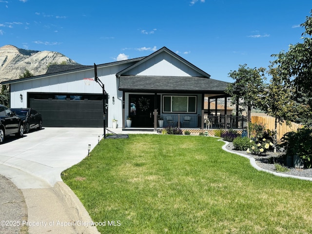 88 Green Mesa Pl, Parachute, CO 81635 - view of front of property featuring a garage, concrete driveway, a porch, a mountain view, and board and batten siding