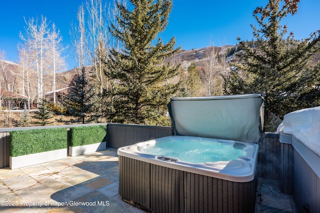 63 Smuggler Grove Rd, Aspen, CO 81611 - view of patio with a hot tub and a mountain view