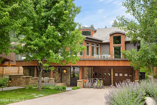63 Smuggler Grove Rd, Aspen, CO 81611 - view of front facade with a garage, driveway, and stone siding