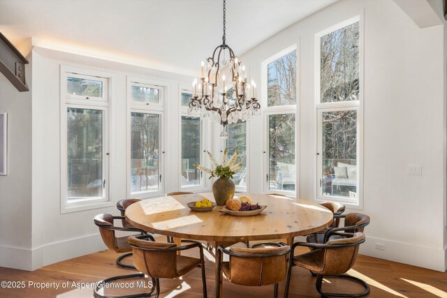 63 Smuggler Grove Rd, Aspen, CO 81611 - dining space featuring wood finished floors and a chandelier