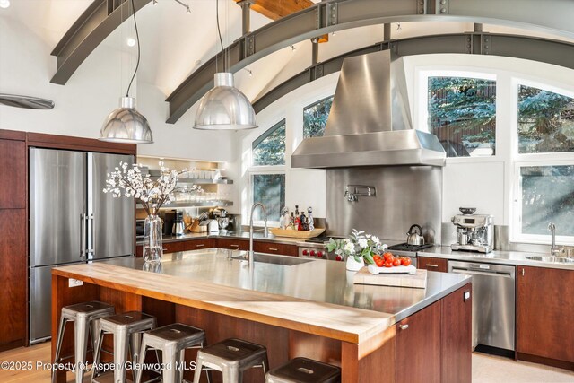 63 Smuggler Grove Rd, Aspen, CO 81611 - kitchen featuring appliances with stainless steel finishes, island exhaust hood, wood counters, high vaulted ceiling, and pendant lighting