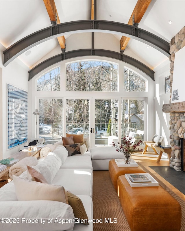 63 Smuggler Grove Rd, Aspen, CO 81611 - living area featuring healthy amount of natural light, beam ceiling, a fireplace, and high vaulted ceiling
