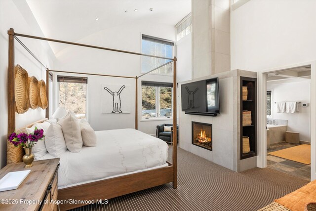 63 Smuggler Grove Rd, Aspen, CO 81611 - bedroom featuring high vaulted ceiling, a tile fireplace, connected bathroom, and recessed lighting