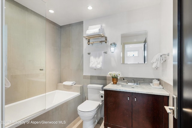 63 Smuggler Grove Rd, Aspen, CO 81611 - bathroom with tile walls, tiled shower / bath combo, vanity, and recessed lighting