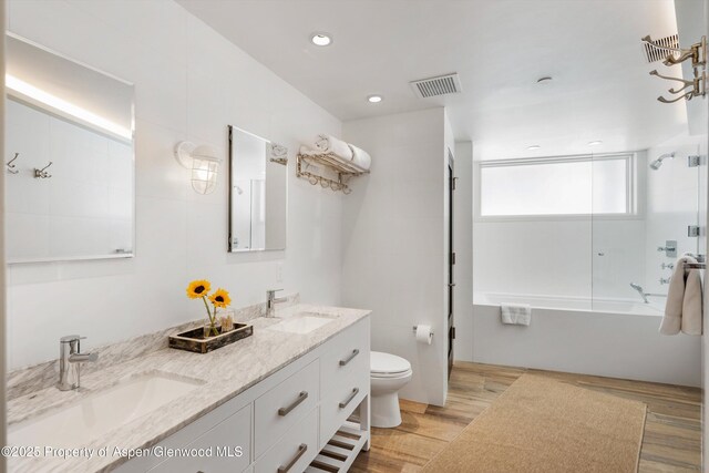 63 Smuggler Grove Rd, Aspen, CO 81611 - bathroom with combined bath / shower with glass door, double vanity, wood finished floors, and recessed lighting