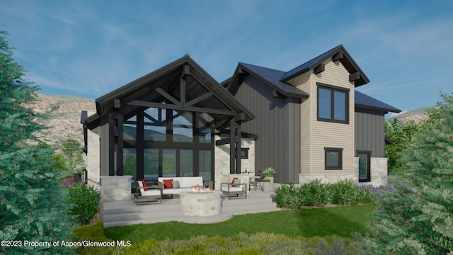 rear view of property featuring a mountain view, a yard, a patio, and a fire pit