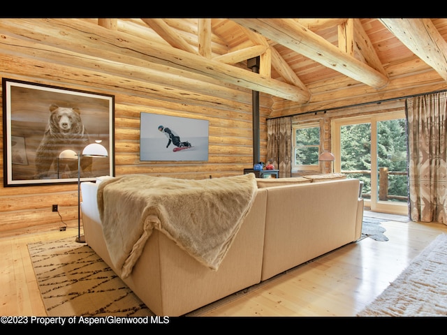 living room with log walls, beamed ceiling, hardwood / wood-style flooring, and wooden ceiling