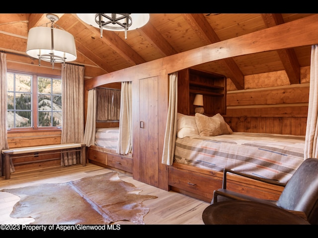 unfurnished bedroom with vaulted ceiling with beams, wood walls, light hardwood / wood-style flooring, and wood ceiling