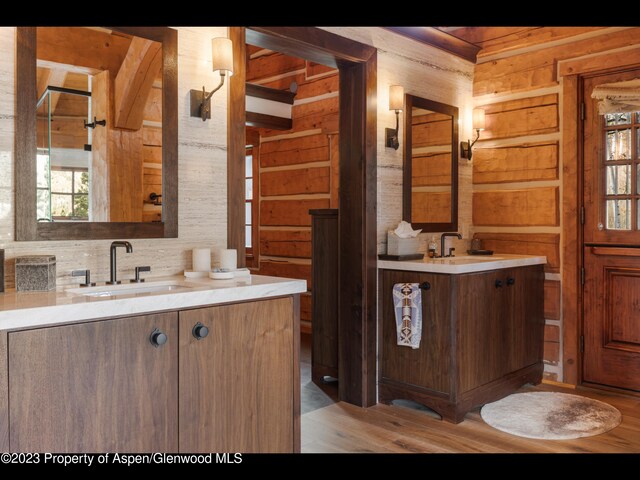 bathroom featuring wood walls and vanity