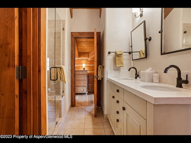 bathroom featuring tile patterned floors, vanity, and an enclosed shower