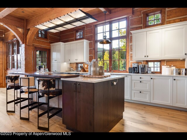 kitchen with a center island, white cabinets, and plenty of natural light