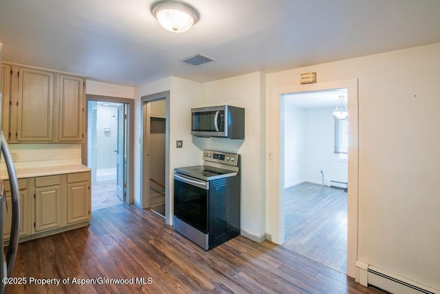1105 Bennett Ave, Glenwood Springs, CO 81601 - kitchen featuring appliances with stainless steel finishes, a baseboard heating unit, dark wood-type flooring, baseboard heating, and light countertops