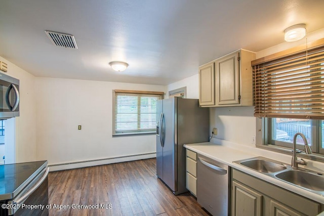 1105 Bennett Ave, Glenwood Springs, CO 81601 - kitchen with appliances with stainless steel finishes, baseboard heating, light countertops, and dark wood-style floors