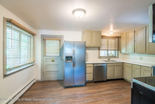 1105 Bennett Ave, Glenwood Springs, CO 81601 - kitchen featuring appliances with stainless steel finishes, a baseboard radiator, light wood-style floors, and light countertops